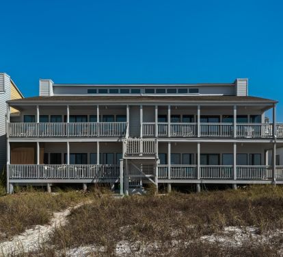 Back of building facing ocean and beach showing wrap-around balcony (top right)
