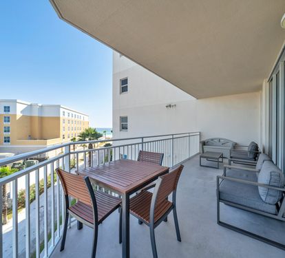 Balcony with partial ocean view with provided beach toys in storage bench