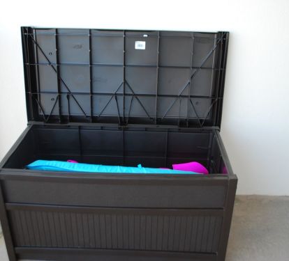 deck box filled with beach toys.