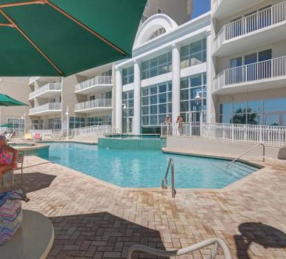 Outside pool w/tables &amp; chairs surrounding it