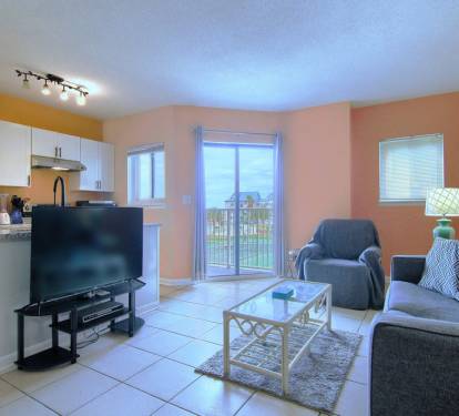 Living Room with Flat Screen TV and Kitchen