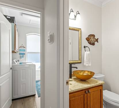First floor HALF BATH and FULL SIZE laundry room with deep sink