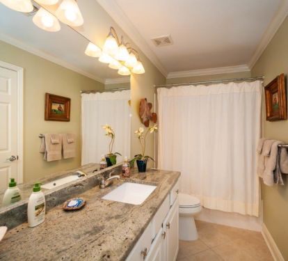 guest bath with granite counter tops and ADA toilet