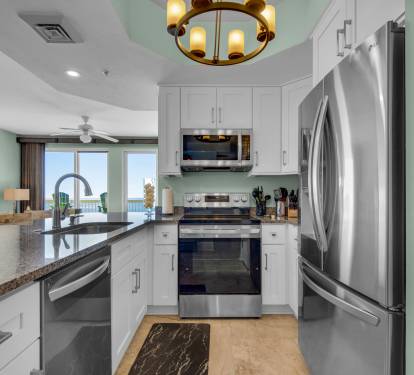 Kitchen view into Living Area with ceiling height cabinets.