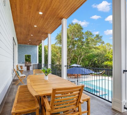 1st floor, house length covered patio has outdoor kitchen and bathroom