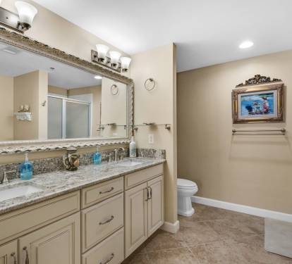 Master Bath having High-End Cabinets, Granite Counters and Framed Beveled Mirrors