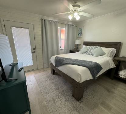 Queen bedroom with balcony access overlooking marina and ocean.