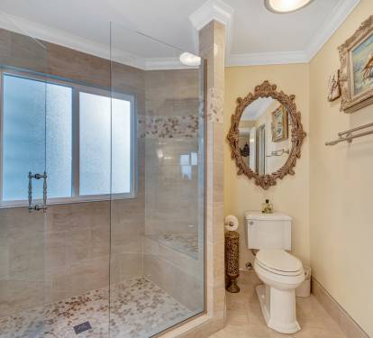 View of Master Bathroom showing Walk-In Stone and Tile Shower and Toilet