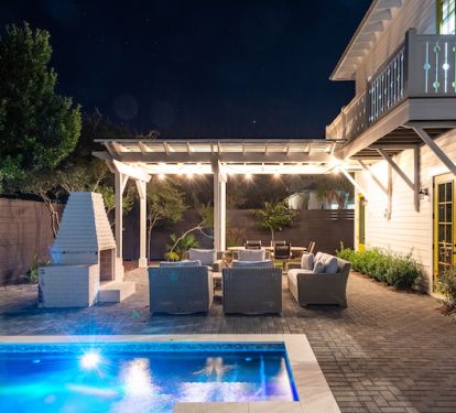 Outdoor Area Equipped with Swimming Pool, Fireplace, and Outdoor Dining