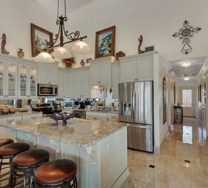 Kitchen with stainless steel appliances, granite counters, porcelain tile