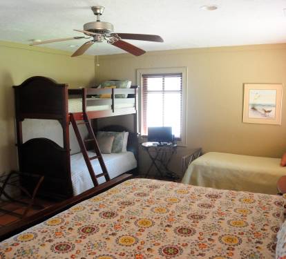 The bedroom with one bunk bed, one single bed, and one king bed