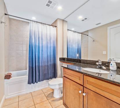 The second bathroom can be accessed from the hallway or the guest room alike