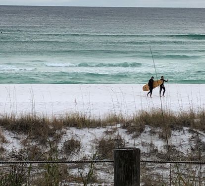 Surfer boys catching some waves outside condo