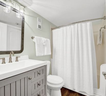 Guest/hall bathroom featuring step-in shower. Lots of drawers for toiletries.