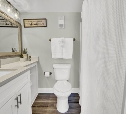 Master bathroom features a tub and has a large mirror and great lighting.
