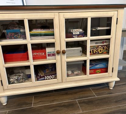 cabinet full of games/cards/puzzles and coloring activities