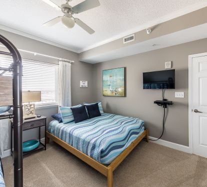 second bedroom with queen and bunk beds- TV in every room