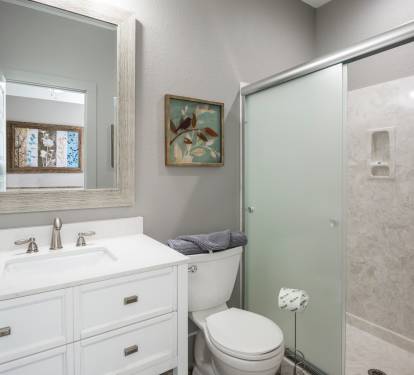 Private bathroom has glassed in shower