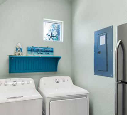 Laundry Room with extra refrigerator.
