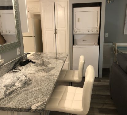 Bar area with washer and dryer.