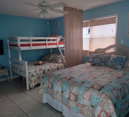 Bedroom with queen bed and bunkbed with lower full bed &amp; upper twin bed.