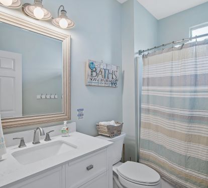 Bathroom located in hallway.