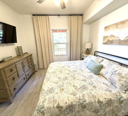 KING Front Bedroom with mirrored closet and private bath access. 