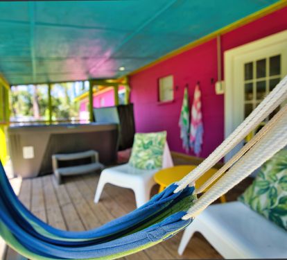 Back Porch with hammock, seating and hot tub.