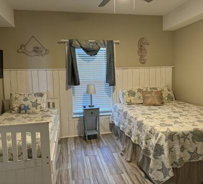 Second bedroom has a queen size bed and a trundle bed.