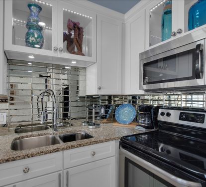 Smoked glass backsplash appointed with color changing LED lights 