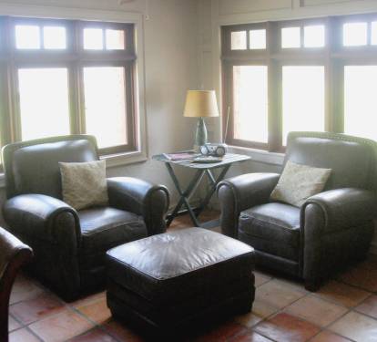 Sitting area by the front door, with windows looking out to the bay