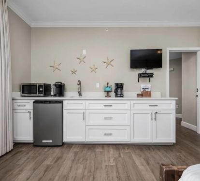 Kitchenette with mini-fridge, microwave, sink and quartz countertops