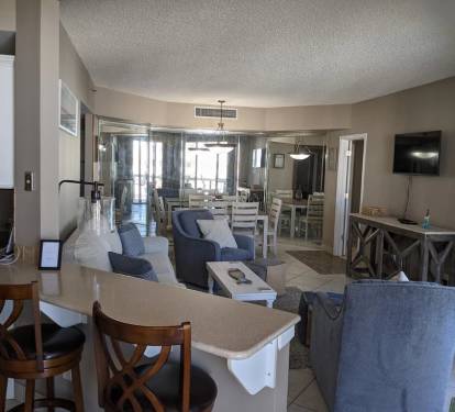 sliding balcony door looking into living room and dining area