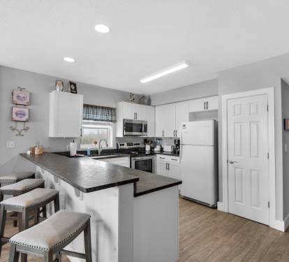 Fully stocked kitchen with breakfast bar.