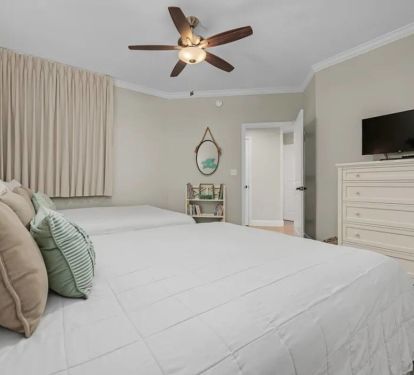 The second bedroom comfortably fits two queen beds and has private entry into the main bathroom