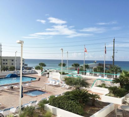 Pool deck with hot tubs, kiddie pool, pool, sunning area, skybridge to beach