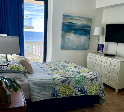 Queen bedroom is cozy and also has great view of the blue water.