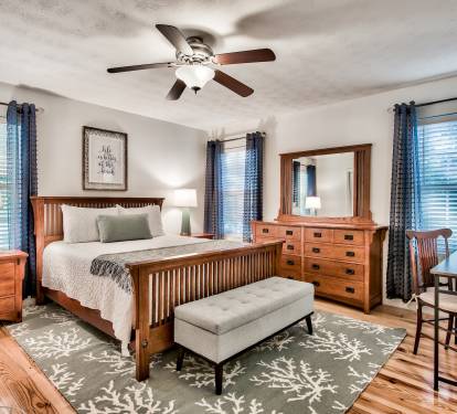 Master bedroom with a queen bed, large closet, workspace and ensuite.