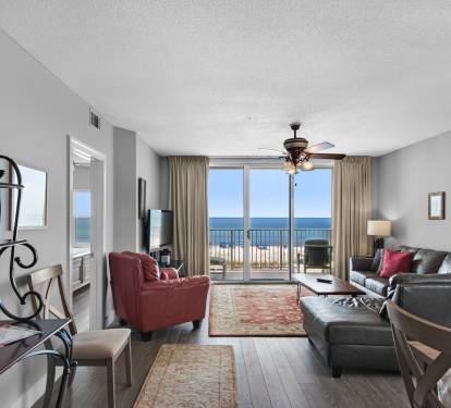 Open concept living room with ocean view and balcony access.