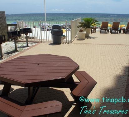 3 BBQ Grills on the pool deck on the beach with picnic tables