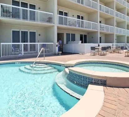 Oceanfront resort pool with loungers and sweeping views of the Gulf