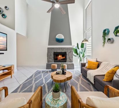 Cozy up at Seabreeze Villa ðŸ”¥ This inviting living room features a warm fireplace and coastal-inspired decor&mdash;perfect for relaxing after a day at the beach. Your seaside escape is just a booking away! ðŸŒ´âœ¨