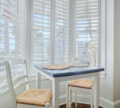 High top dining area for two with bay window to balcony