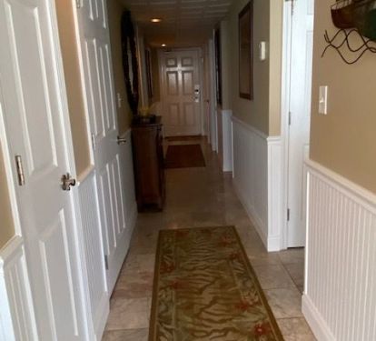 Entrance hallway with wood beadboard trim. 