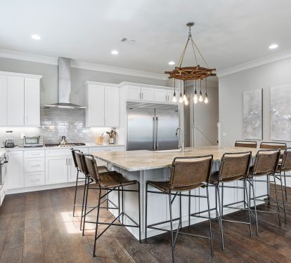 Kitchen has large island with comfortable seating on 3 sides