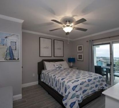 The queen bedroom is right off the living room and opens up to the first balcony