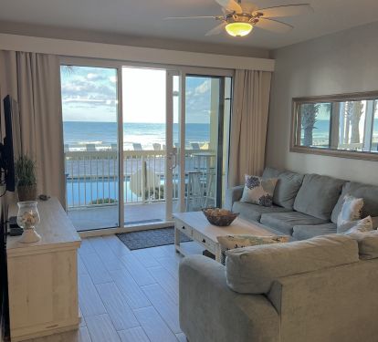 A beautifully updated living room with views of the Gulf with endless shades of blue stretching to the horizon.