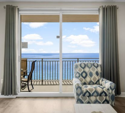 Bright coastal living area with sliding doors to private balcony