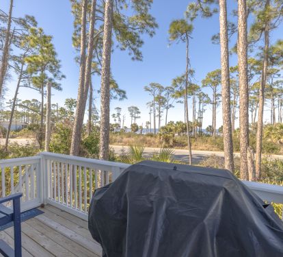 Outdoor grilling area with seating facing the bay