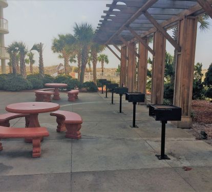 Grill area for guest use is located at the side of the condo by the pool area